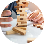 Hands balancing wooden blocks to show risk management and stability
